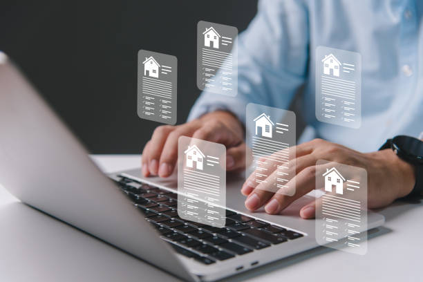 Person typing on a laptop with translucent property listing cards floating above the keyboard
